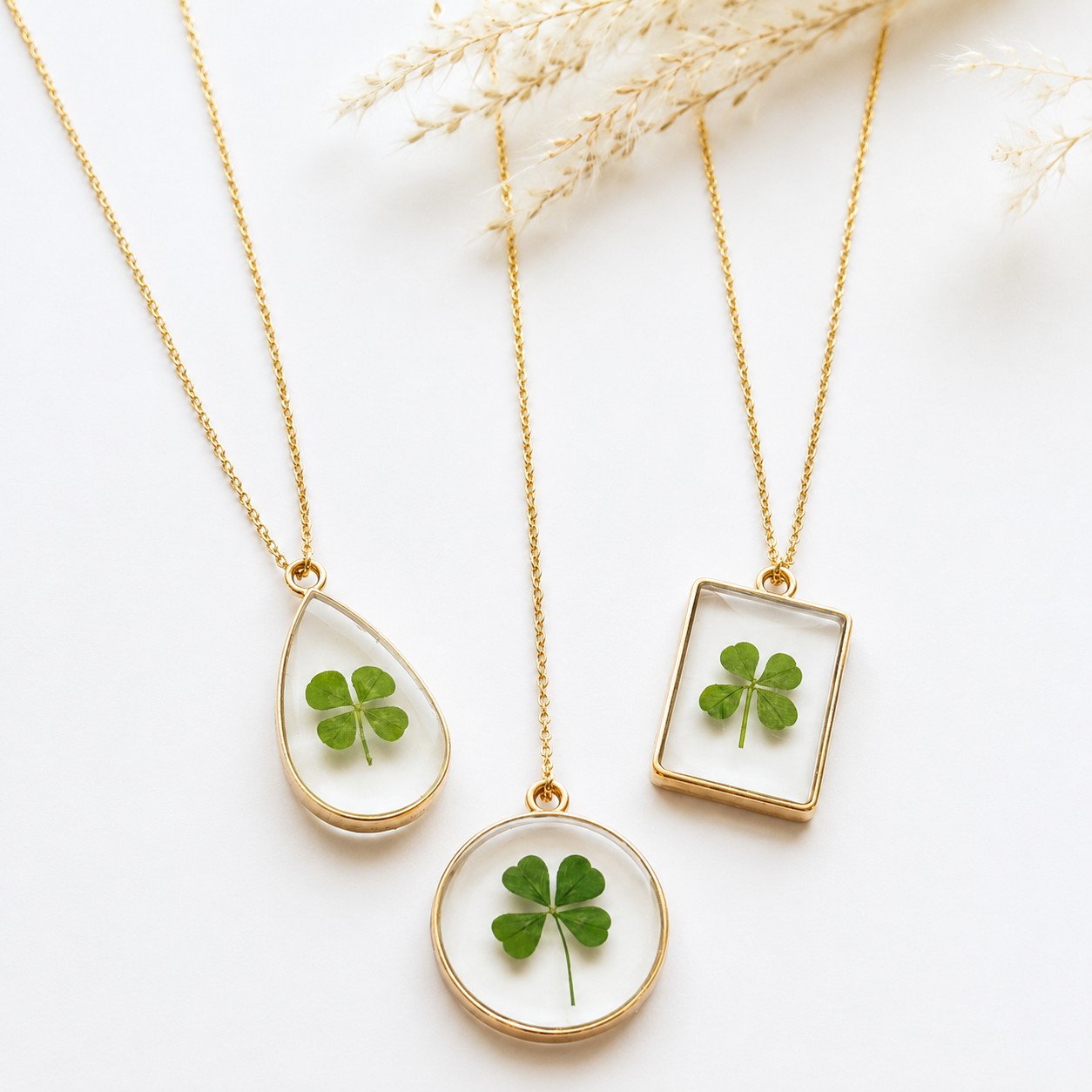Real four-leaf clover necklaces in teardrop, circle and rectangle